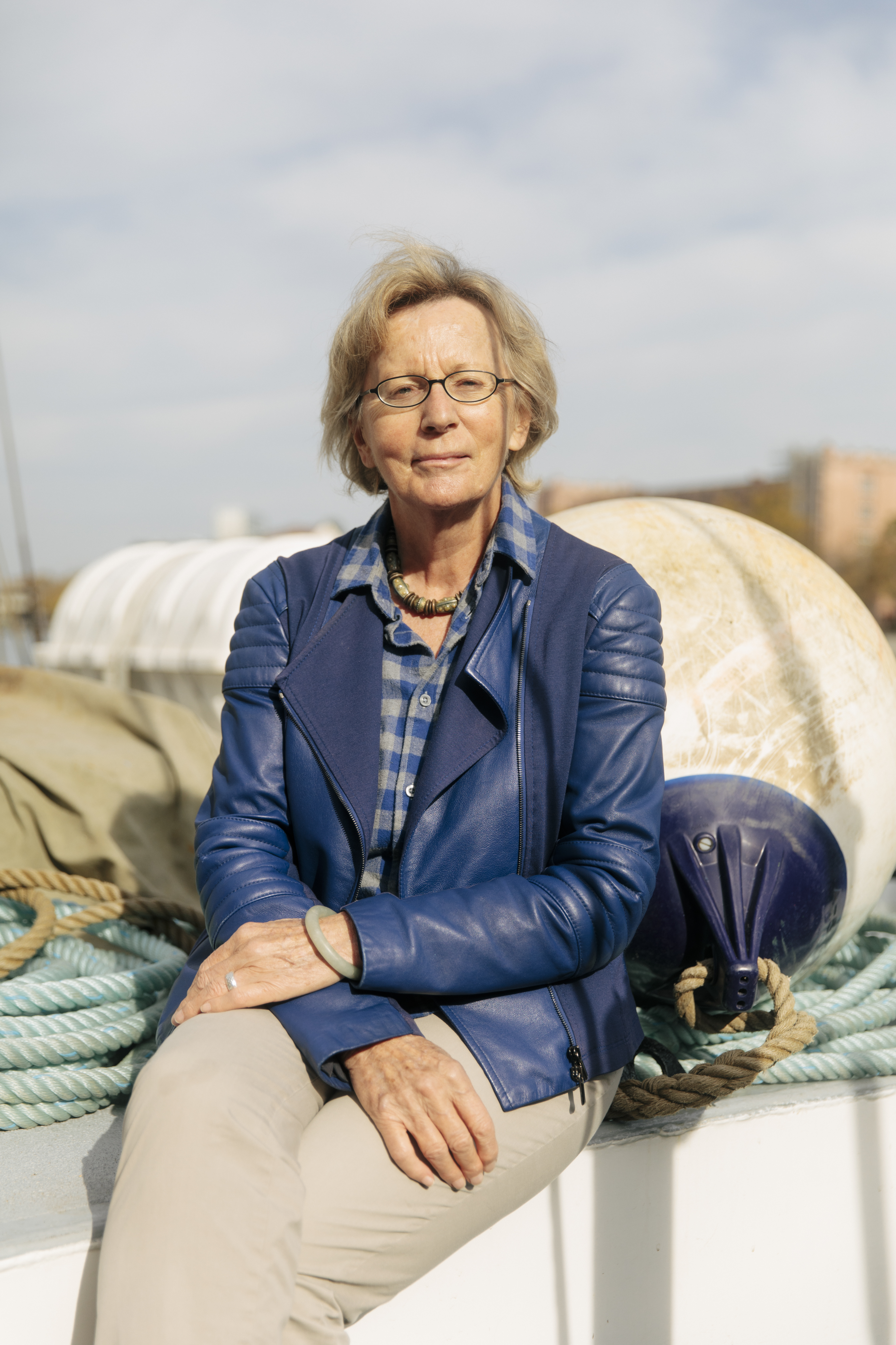 Klimaseniorinnen board member Elisabeth Stern, 77, sits aboard a small boat.