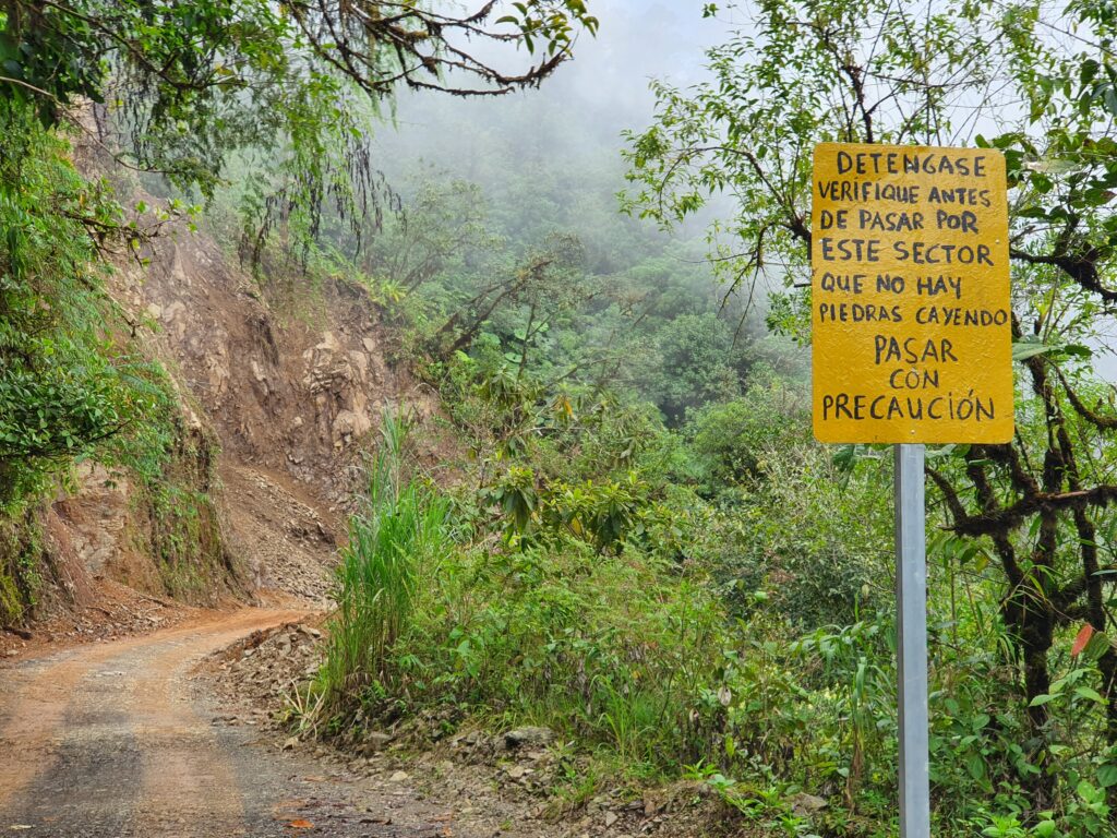 Yellow sign on the Camino de Costa Rica, warning travellers to proceed with caution