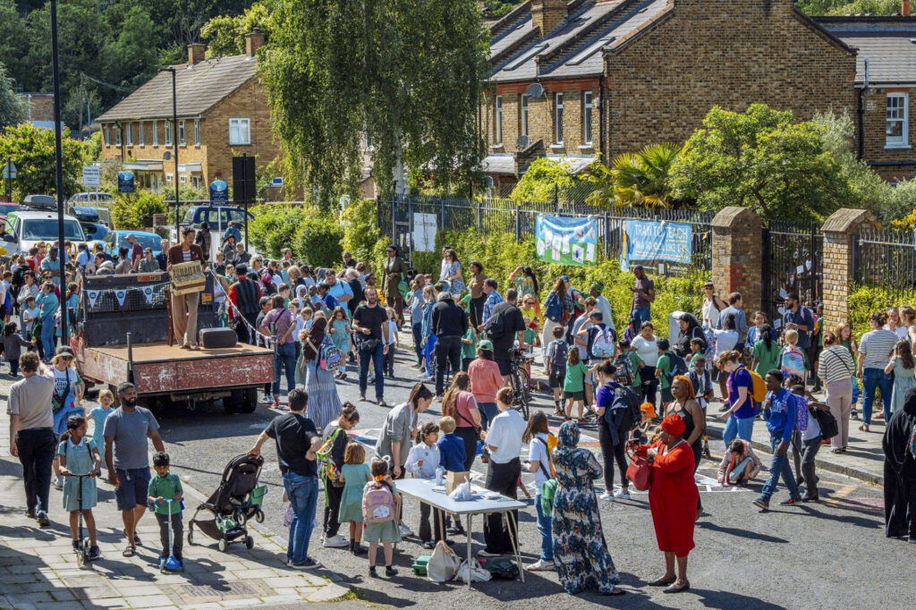 A colourful scene of people gathering on a car-free street