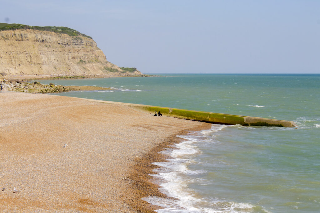 A section of coastline with a cliff and a sandy beach