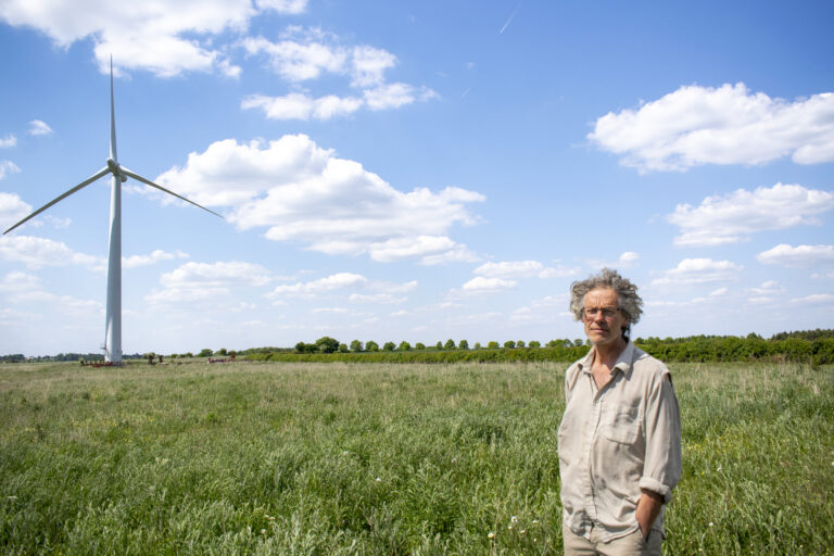 An image of a farmer with a wind turbine