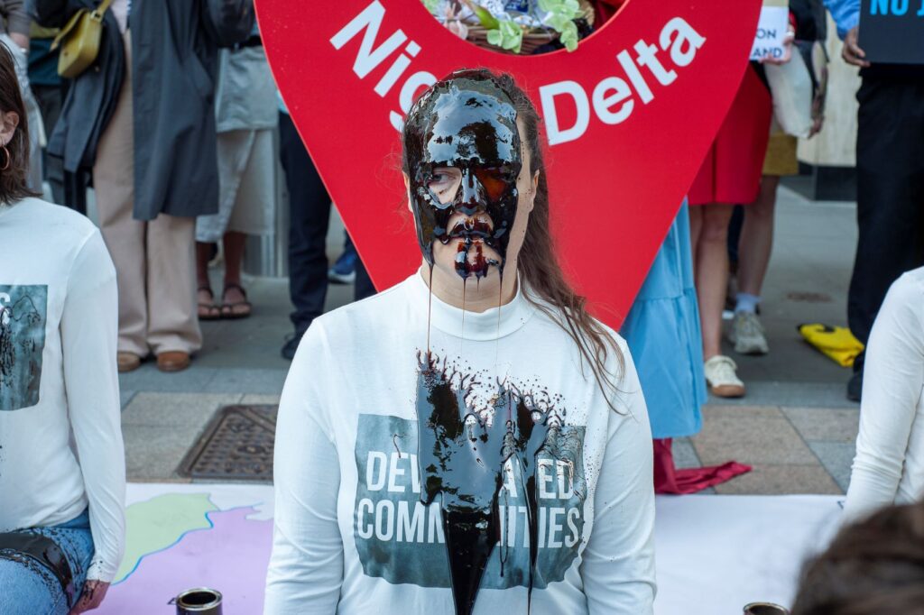 A protester covered in fake oil at a demonstration against the oil giant in London