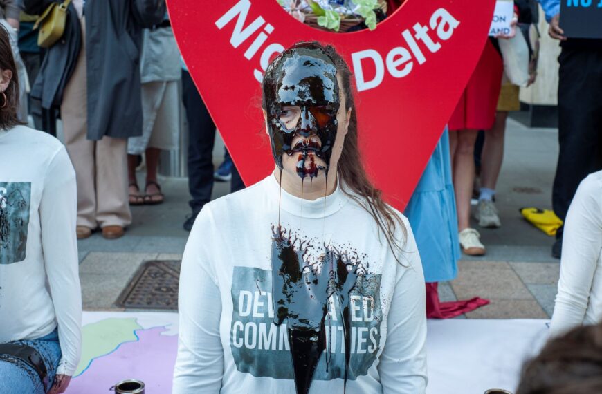 A protester covered in fake oil at a demonstration against the oil giant in London