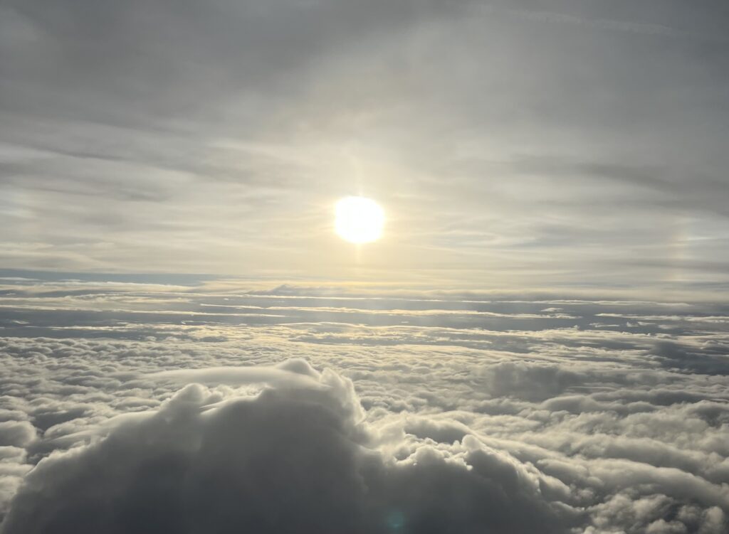 The sun shining above the clouds