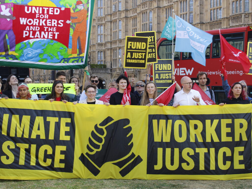 Climate and worker justice protestors outside the houses of parliament