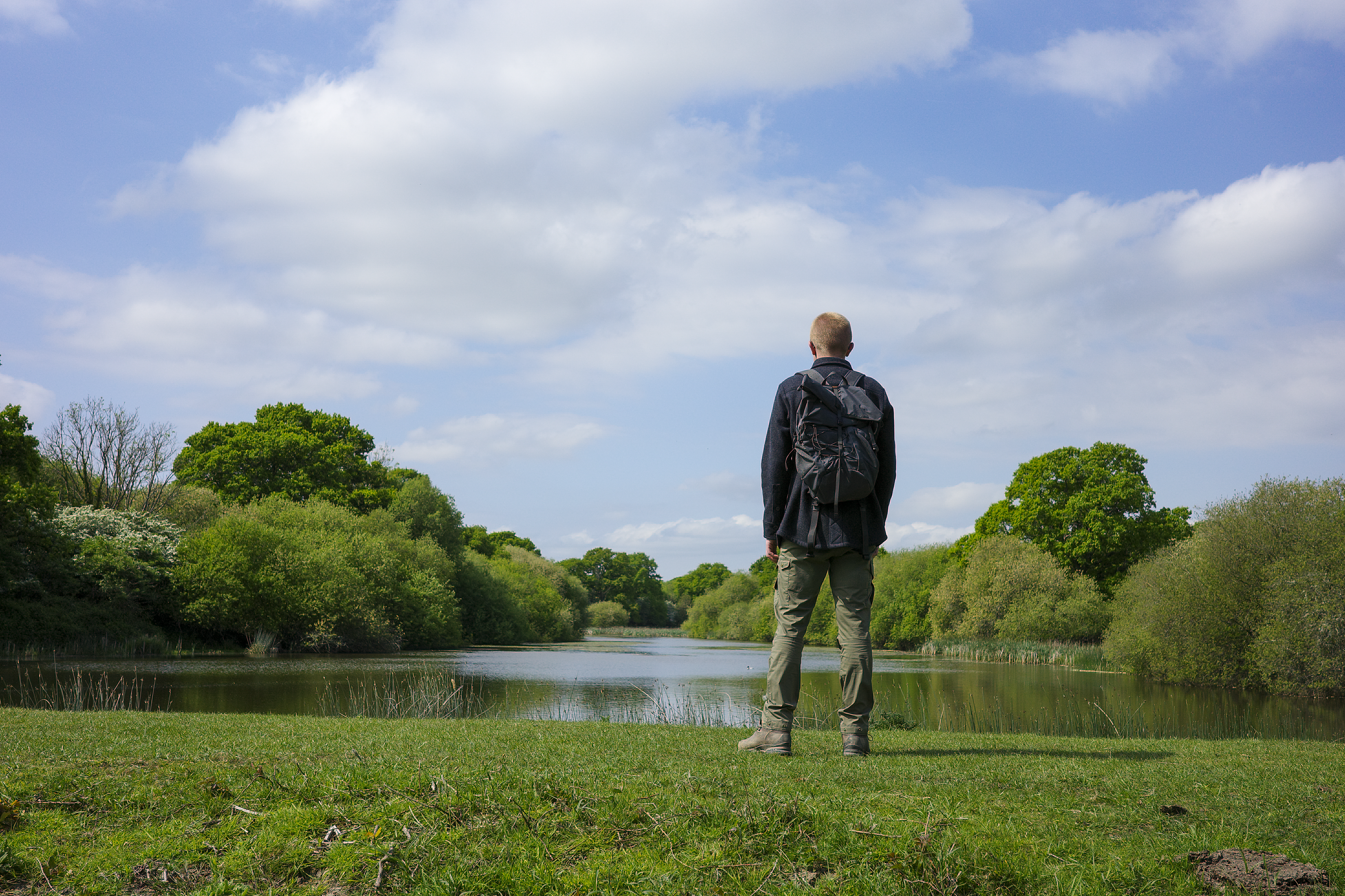 Ned Win standing over a lake on the Knepp Estate