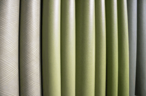 A row of textiles made of organic materials, in a range of green tones