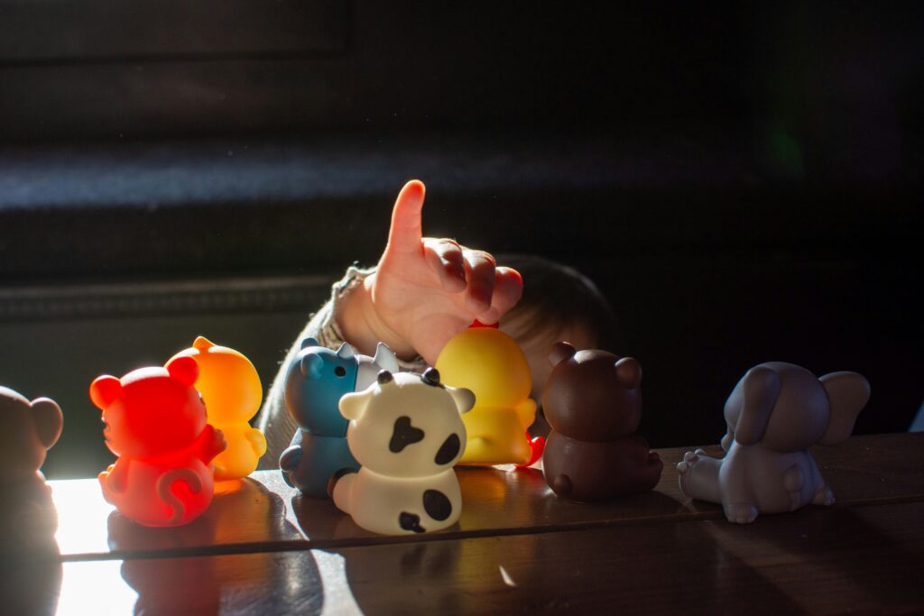 A child's hand reach out to some toys